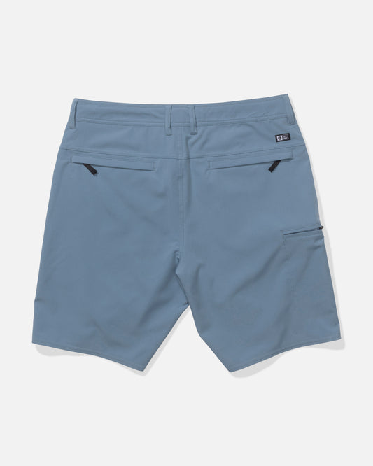 Back view of Salty Crew Transom 19" Tech Short in Pilot Blue, made from quick-dry, lightweight fabric with two zippered back pockets, a right-side pocket, and a small logo tag above it. Smooth material ensures all-day comfort.