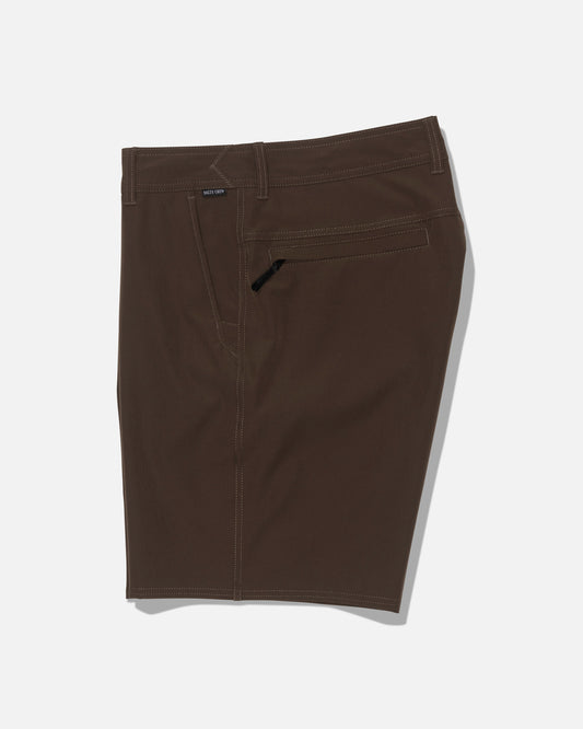 Salty Crew’s Transom 19″ Tech Short in Washed Brown features a quick-dry fabric with subtle 4-way stretch for optimal comfort and mobility. Designed with a waistband, belt loops, zip fly, and back pocket, these shorts offer both convenience and style. Shown laid flat on a white background.