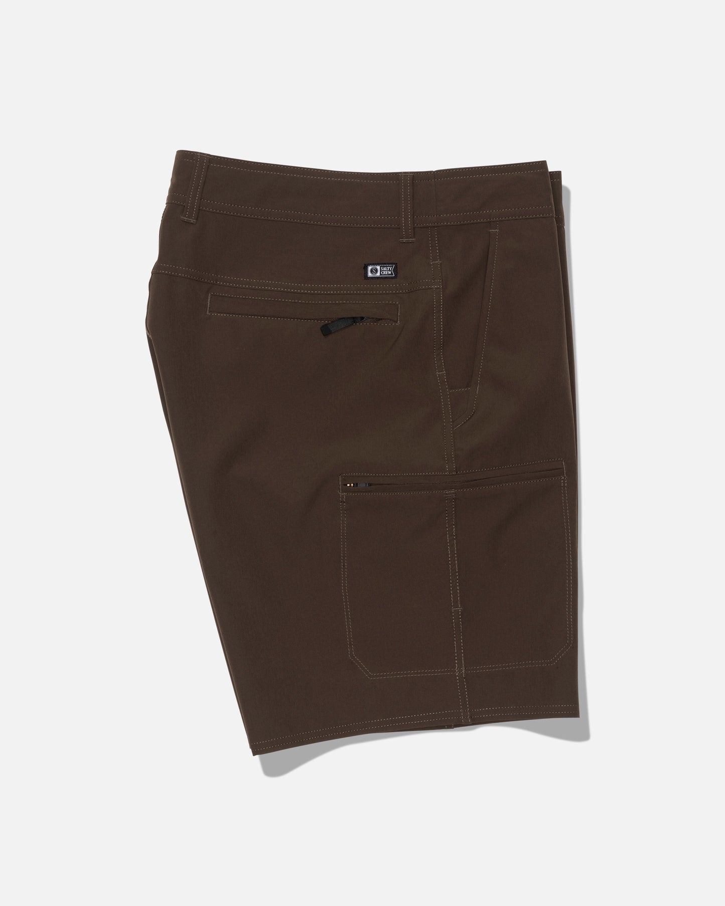Salty Crew’s Transom 19″ Tech Short in Washed Brown features white stitching, a side zipper pocket, a buttoned waistband, additional side and back pockets, and a straight leg design. Made from quick-dry fabric for comfort and practicality, these knee-length shorts are displayed on a plain white background.
