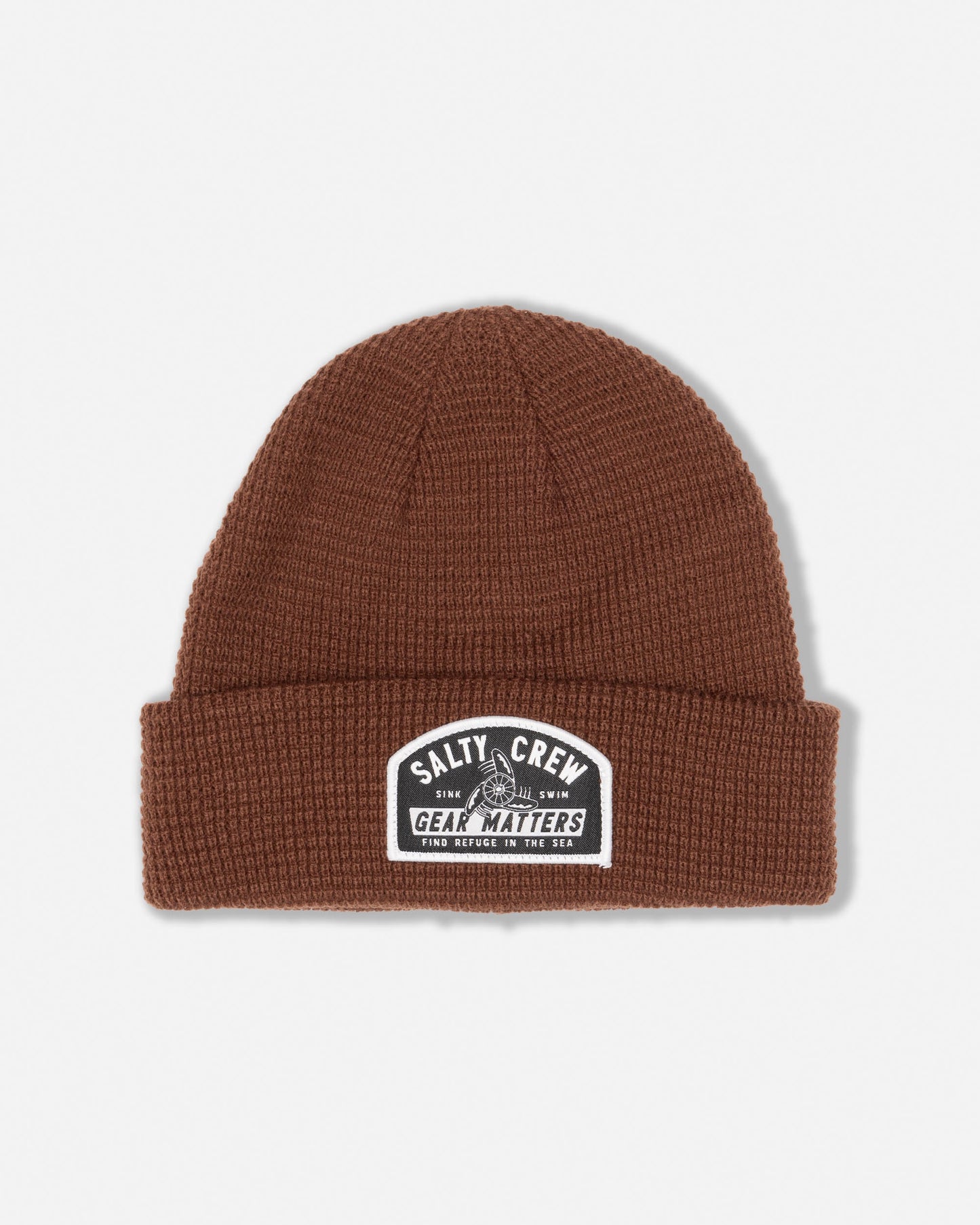The Coastal Beanie - Root Beer by Salty Crew is a brown acrylic waffle knit beanie with a folded brim, featuring a black and white “Gear Matters” patch on the front. This classic woven patch beanie delivers both warmth and style for your everyday adventures.