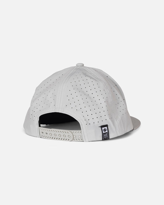 The Long Range Snapback - Harbor Grey by Salty Crew is a white polyester structured cap, displayed from the back, highlighting its small ventilation holes, adjustable snapback strap, and a small black and white Salty Crew label on the side.