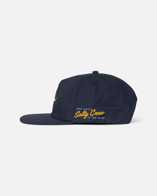 The Salty Crew Coastal Boys Snapback in Midnight Navy is a cotton canvas cap with yellow and white “FIND REFUGE IN THE SEA” embroidery on the side, a flat brim, and an adjustable snapback closure.
