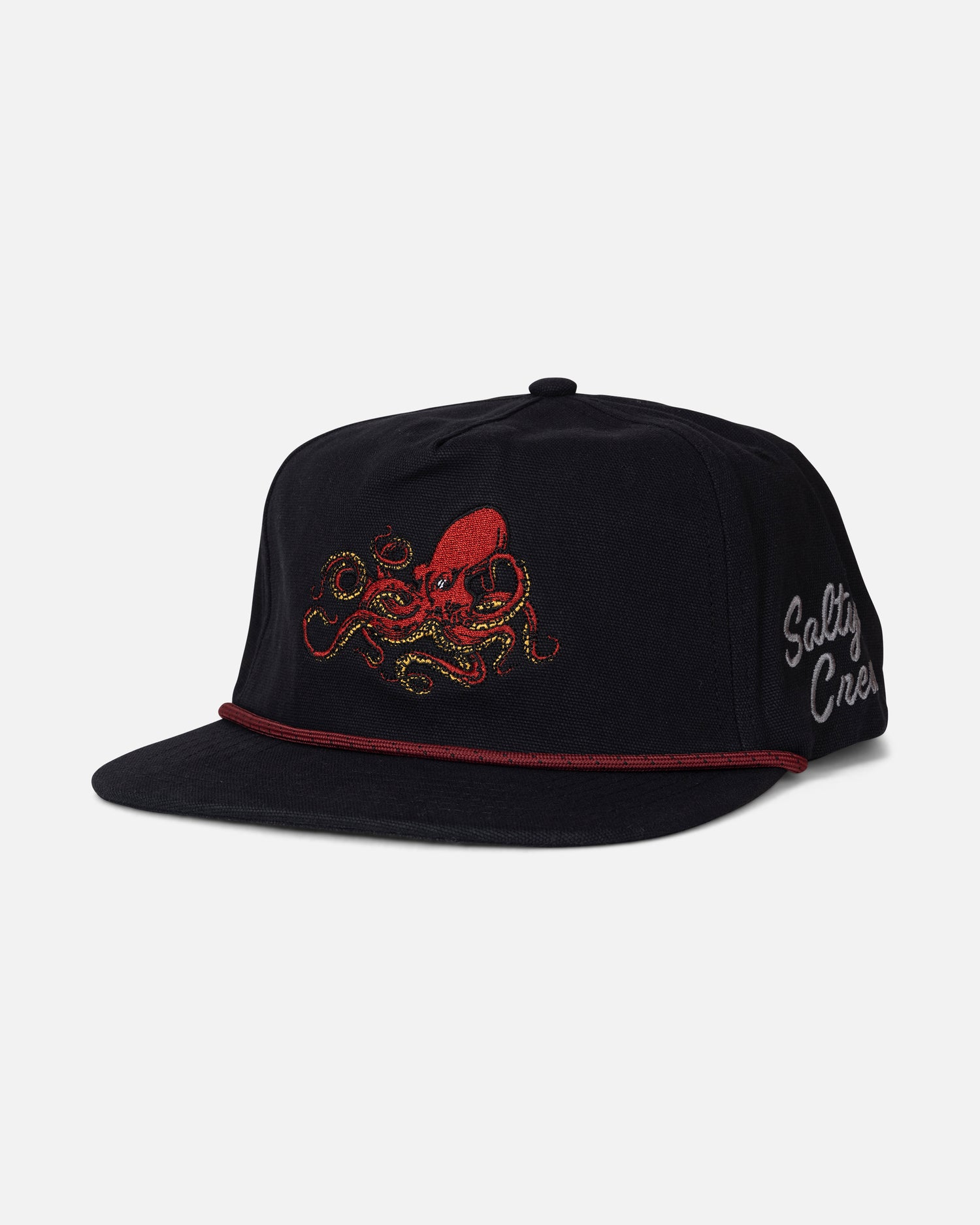 Introducing the Salty Crew Coastal Snapback - Black: a durable cotton canvas 5-panel snapback hat featuring a bold red and yellow embroidered octopus on the front, a red cord detail above the brim, and “Salty Crew” stitched in white on the side.