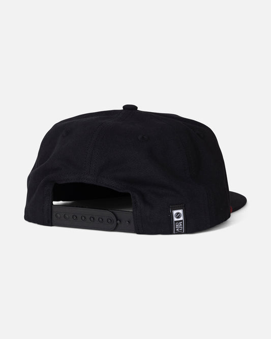 The Salty Crew Coastal Snapback - Black is displayed from the back against a plain white background. Made from durable cotton canvas, it features a five-panel design, an adjustable snapback strap, and a small black-and-white Salty Crew tag near the opening.