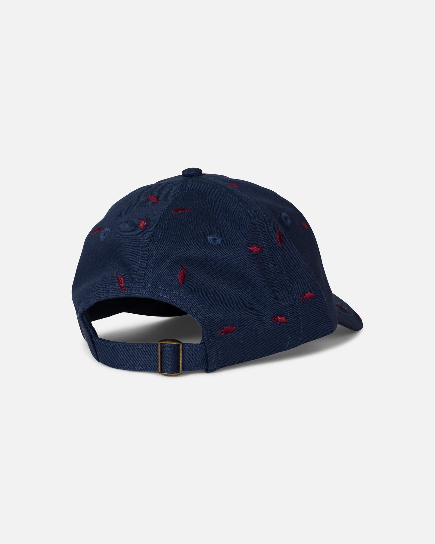 The Salty Crew Nice Catch Hat in True Navy is an unstructured cotton cap featuring an adjustable strap and small red embroidered accents scattered across the fabric. The image shows the hat from the back.