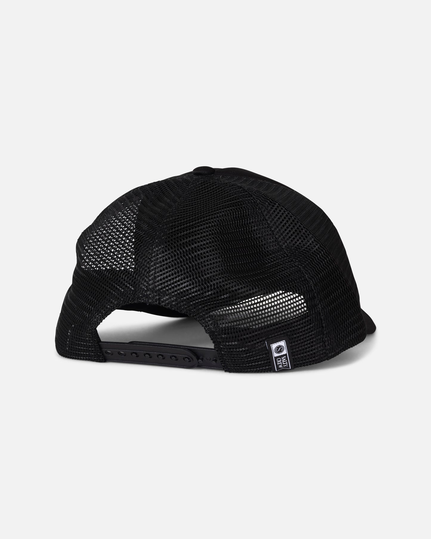 A rear view of the Salty Crew Seaside Trucker - Black hat highlights its breathable mesh back, adjustable snapback closure, and a subtle Salty Crew brand label on the back panel, all set against a plain light grey background.
