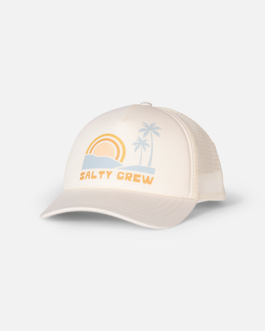 The Seaside Trucker - Off White by Salty Crew is a beige foamy trucker hat with a moisture-wicking mesh back, featuring a front panel graphic of a sunset, palm trees, ocean waves, and the words “Salty Crew”.
