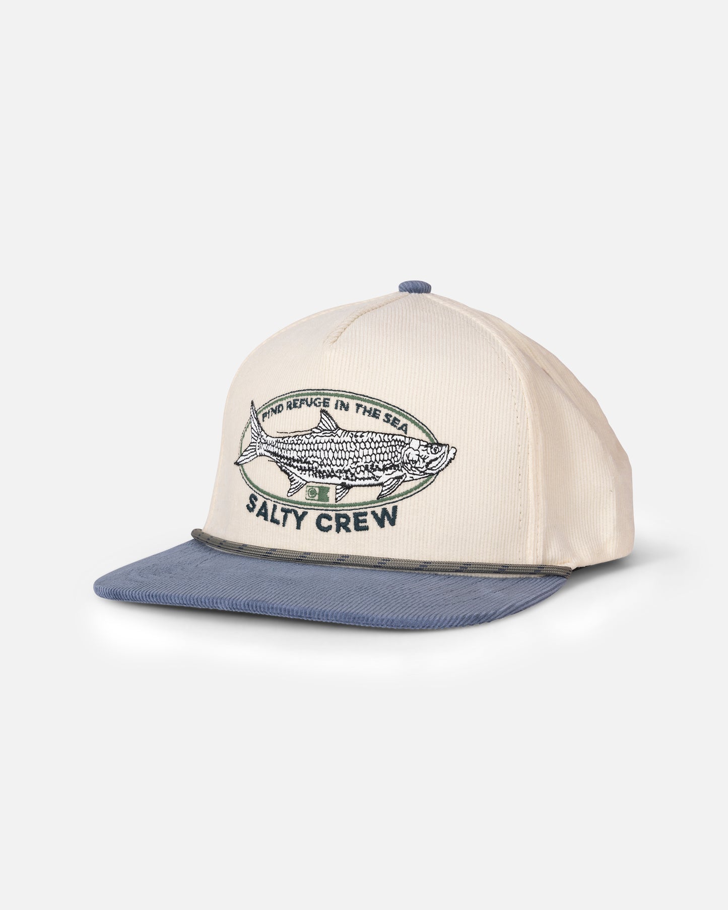 The Salty Crew Tarpon Snapback in Off White Blue is a cotton corduroy hat featuring embroidered fish artwork and the phrases “FIND REFUGE IN THE SEA” and “SALTY CREW” on the front. This snapback cap includes a flat blue brim and mesh side panels.
