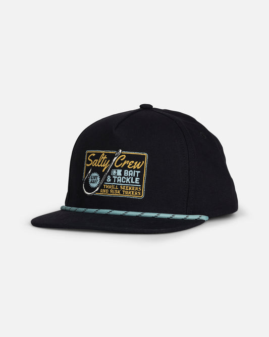 The Salty Crew Hooked Up Boys Snapback in black is a cotton 5 panel baseball cap with a flat brim, featuring a light blue rope detail along the crown. This snapback showcases an embroidered patch that reads “Salty Crew Bait & Tackle, Thrill Seekers and Risk Takers” with a fishing hook graphic.
