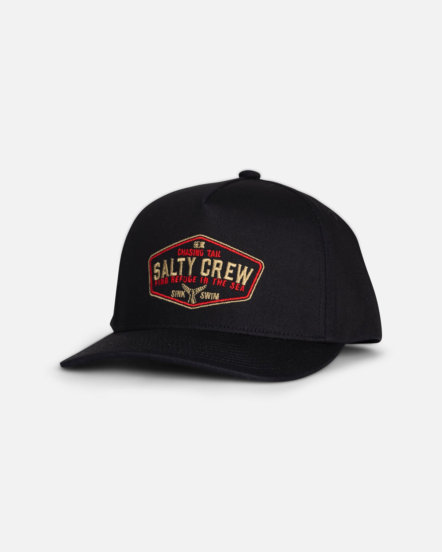 The Tailfin Boys Snapback - Black by Salty Crew is a black cotton 5-panel hat featuring a red and yellow embroidered patch on the front that reads “Salty Crew” and “Chasing Tail.” The snapback cap is photographed against a plain white background.
