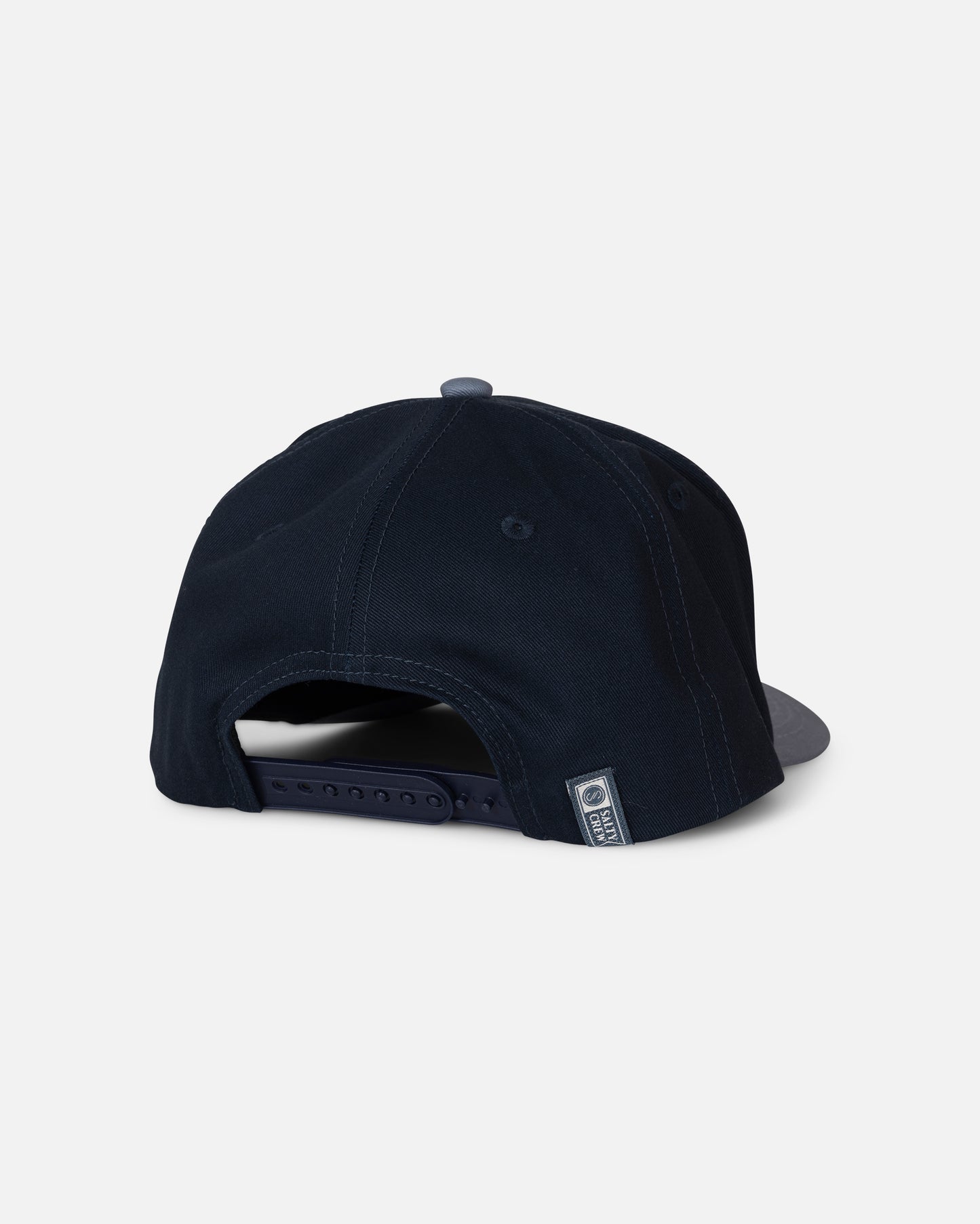 The Salty Crew Tailfin Snapback - Mid Blue is displayed from the back, highlighting its adjustable snapback closure and a small label on the left side. The background is plain white.