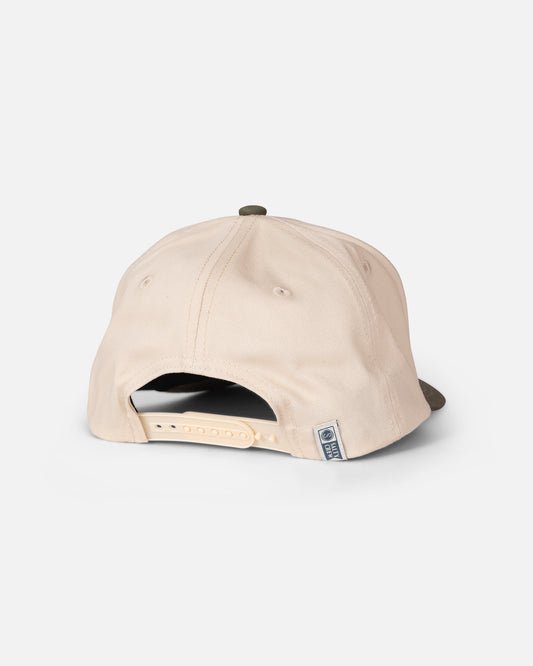 The Salty Crew Tailfin Snapback in Off White/Green is shown from the back, featuring an adjustable strap and a small fabric tag near the opening. The background is plain white.