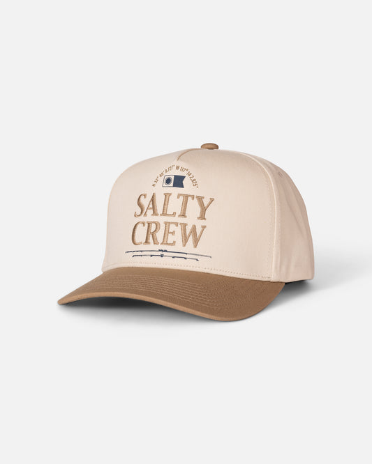 The Salty Crew Coordinates Snapback in Off White/Tan is a cotton high-crown snapback cap featuring beige and brown embroidery, “Salty Crew” stitched on the front, a small patch above the text, and a curved brim. The cap is displayed on a white background.