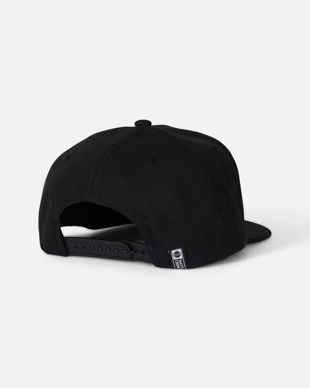 The Salty Crew Red Fish Snapback - Black is a black acrylic wool baseball cap with a structured 6-panel design, shown from the back. It features an adjustable strap and a small woven patch hat tag near the opening, set against a plain light gray background.