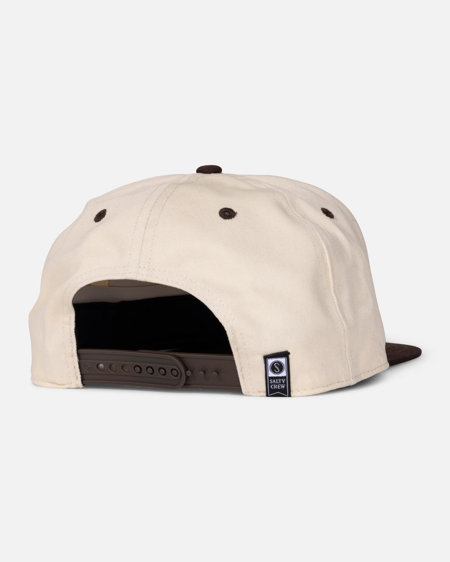 A cream and brown snapback cap displayed from the back, featuring an adjustable plastic strap and a small black and white Salty Crew tag near the opening. This exclusive Padres Catch of the Day Hat - Bone combines classic San Diego Padres hat style with distinctive touches from Salty Crew.