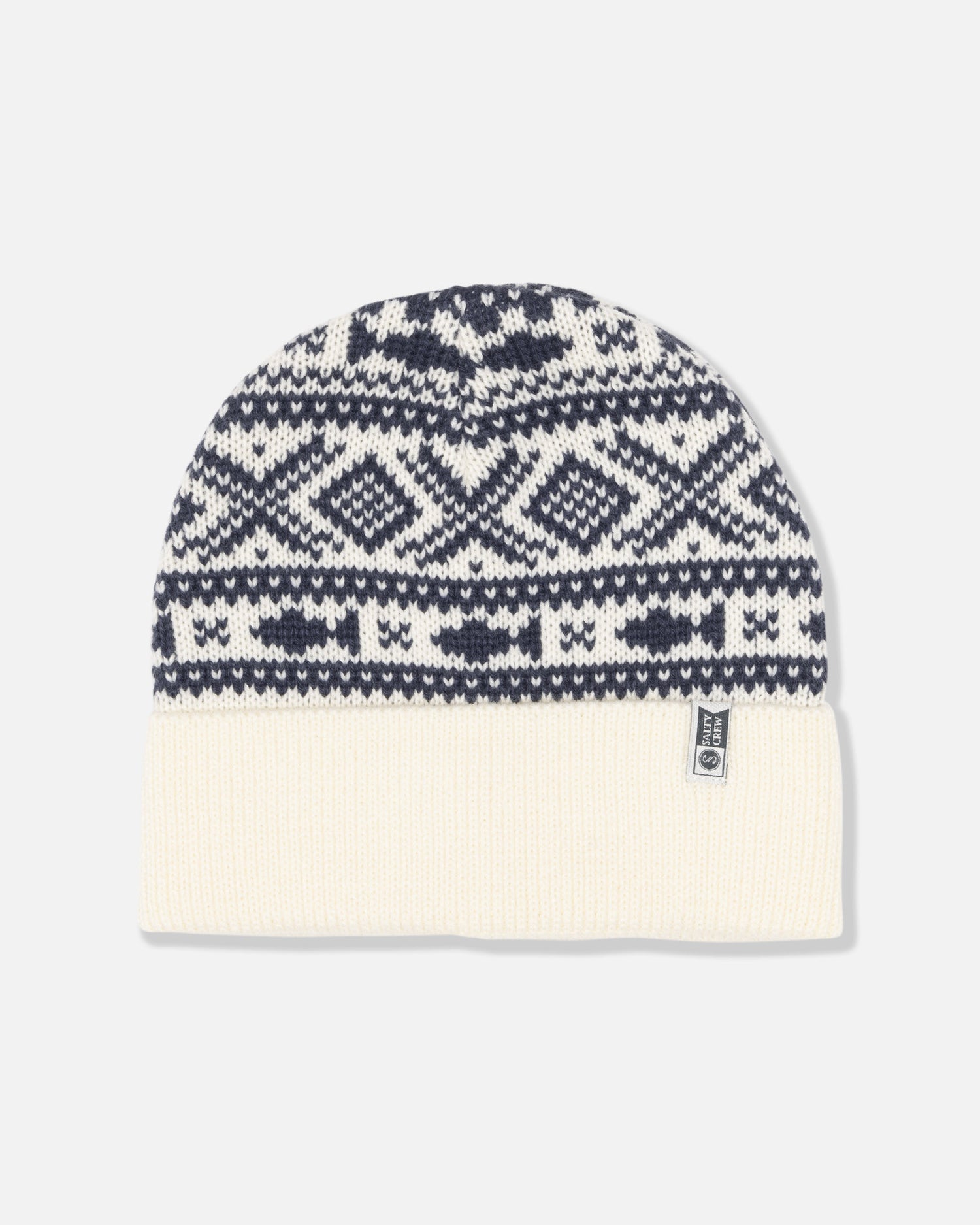 The Out To Sea Beanie - Off White by Salty Crew features a black and white geometric jacquard pattern with a solid off-white turnback cuff, finished with a small rectangular brand tag on the brim.