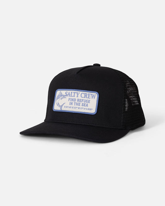The Salty Crew Coordinates Trucker - Black is a high crown snapback profile trucker hat, crafted with black mesh panels and a cotton snapback closure. It features a white and blue patch with the words “Salty Crew Find Refuge in the Sea” and coordinates on the front, displayed against a plain white background.