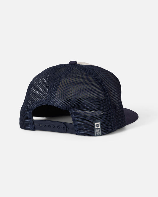 The Salty Crew Coordinates Trucker - Off White/Navy is displayed from the back, showcasing its classic 5 panel design with navy blue mesh, an adjustable snap closure, and a small rectangular tag near the strap.
