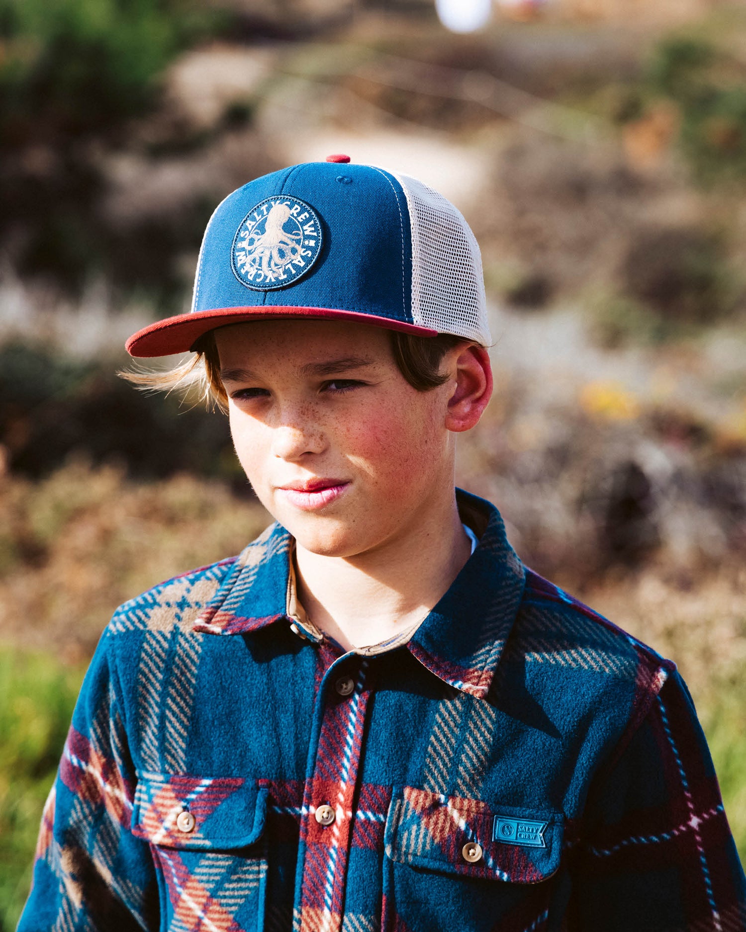 Lifestyle shot of the Tentacles Boys Retro Trucker Hat - Navy/Burgundy. 