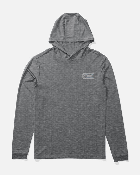 Salty Crew’s Coordinates Hood Sunshirt in Charcoal Heather is a gray, long-sleeve hooded shirt featuring a small rectangular logo with white text and a minimal graphic on the left chest. Made with moisture-wicking fabric for comfort, the shirt is displayed laid flat on a white background.