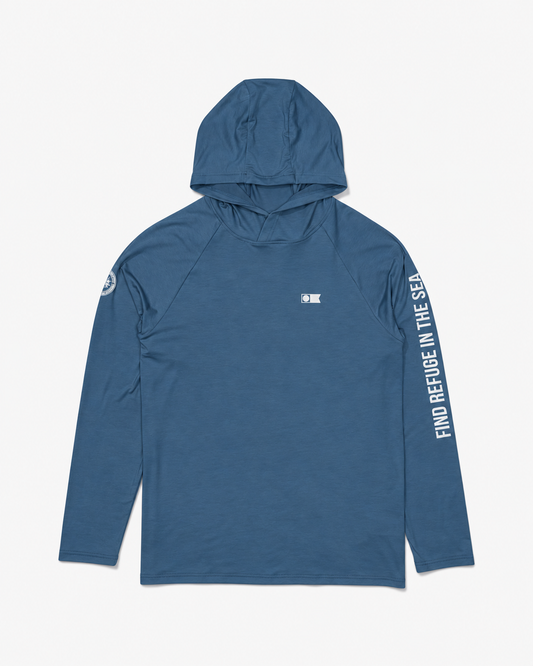 Salty Crew Mariner Lite UV Hood in Cast Blue, featuring moisture-wicking fabric, a white chest logo, a circular right-sleeve emblem, and FIND REFUGE IN THE SEA printed vertically down the left sleeve.