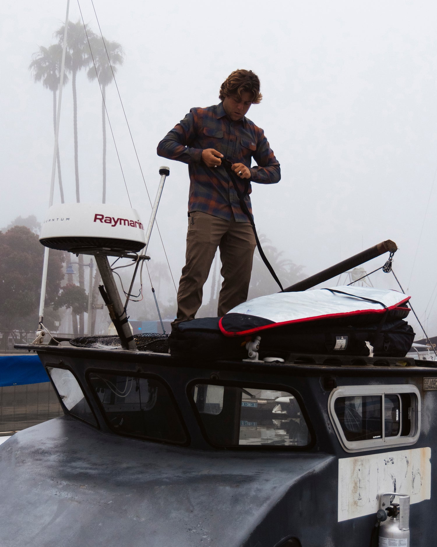 Lifestyle shot of model on top of a boat 