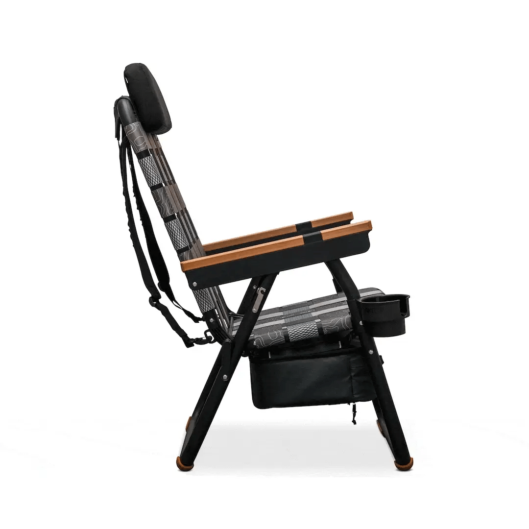 Side view of a Parkit x Salty Crew Eclipse Recliner featuring a patterned seat and backrest, wooden armrests, a headrest, and an integrated cooler with a built-in cup holder and storage compartment.