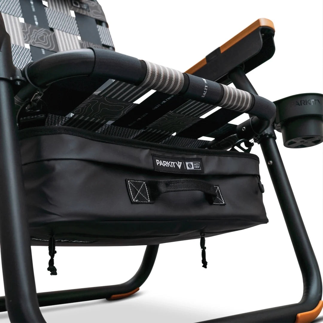 A Parkit x Salty Crew Eclipse Recliner chair featuring a black storage cooler attached beneath the seat and a built-in cup holder on the armrest.