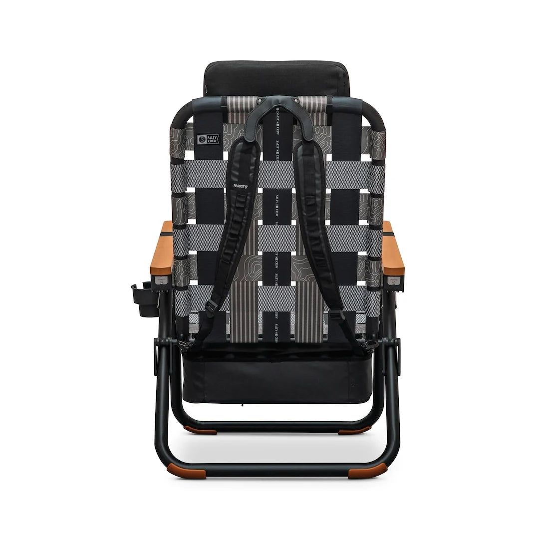 Back view of a Parkit x Salty Crew Eclipse Recliner featuring a gray and black patterned webbing backrest, wooden armrests, and attached backpack straps.