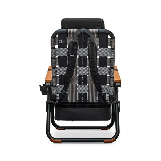 Back view of a Parkit x Salty Crew Eclipse Recliner featuring a gray and black patterned webbing backrest, wooden armrests, and attached backpack straps.