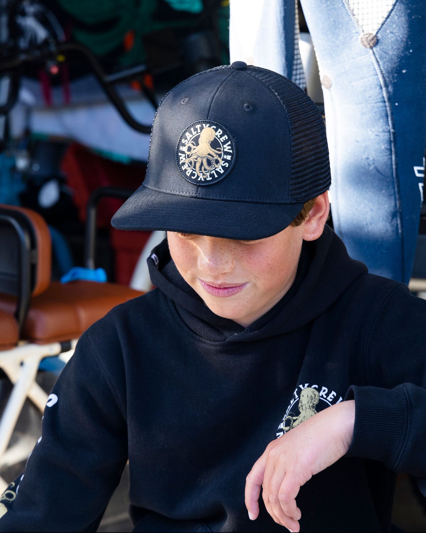 Lifestyle shot of the Tentacles Boys Retro Trucker Hat - Black. 