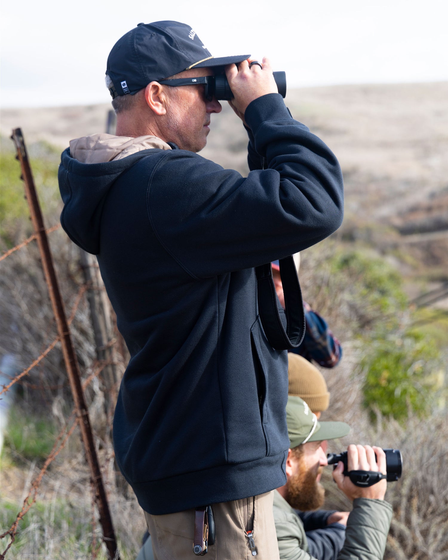 Lifestyle shot of the Westward Tech Fleece Hoodie - Black. 