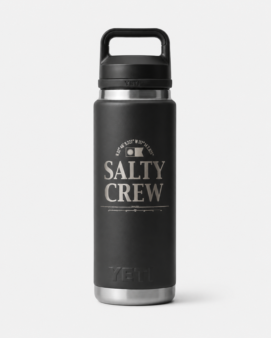 The Salty Crew Yeti x Salty Crew Rambler 26 Oz Black Water Bottle features a handle, silver base, and white SALTY CREW text with coordinates on the front. Made of durable stainless steel with vacuum insulation for lasting performance.