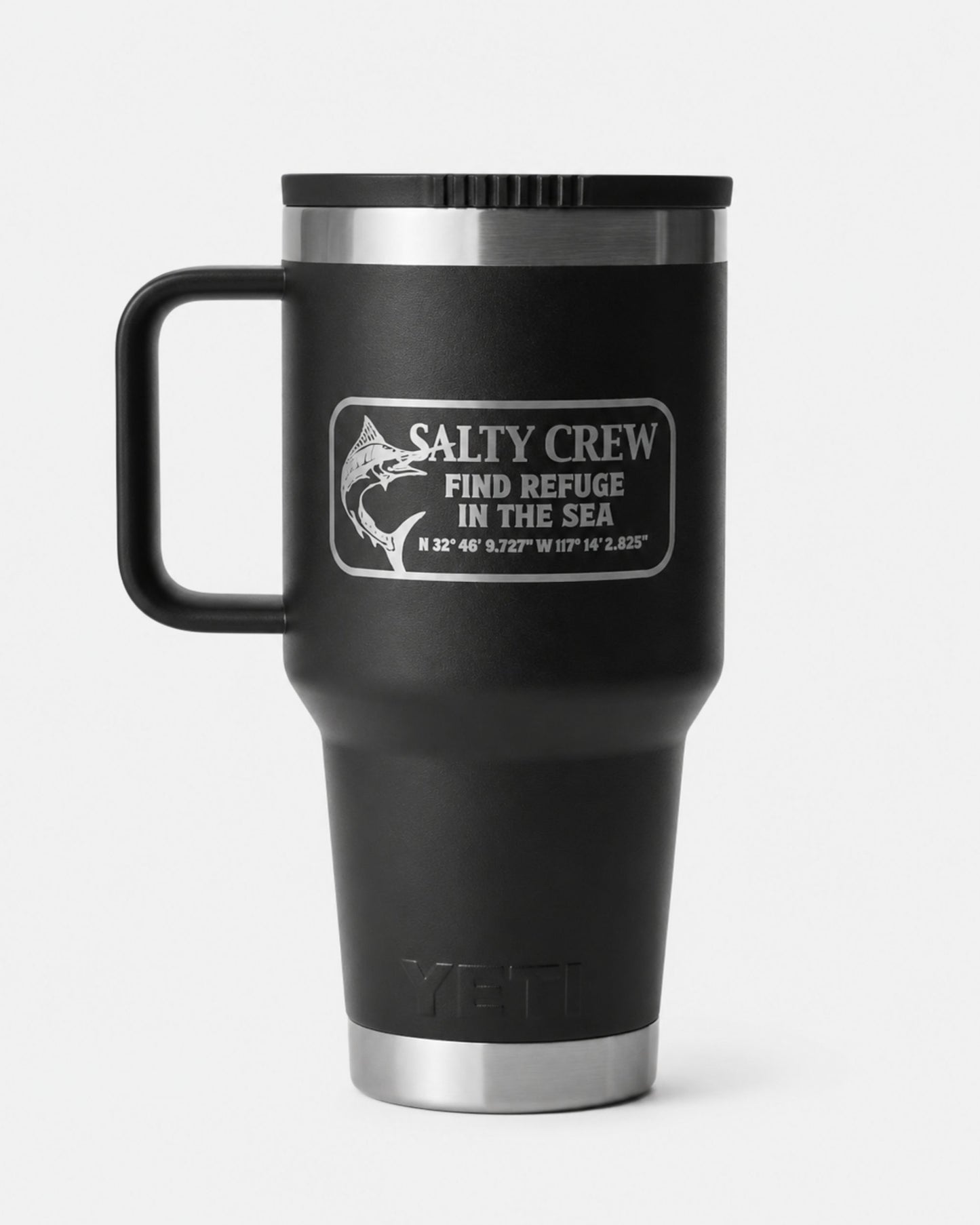 The Salty Crew Yeti x Salty Crew Travel Straw Mug 30 Oz in black is a vacuum-insulated stainless steel mug with handle, featuring a fish graphic, coordinates, and "Find Refuge in the Sea" on a crisp white background.