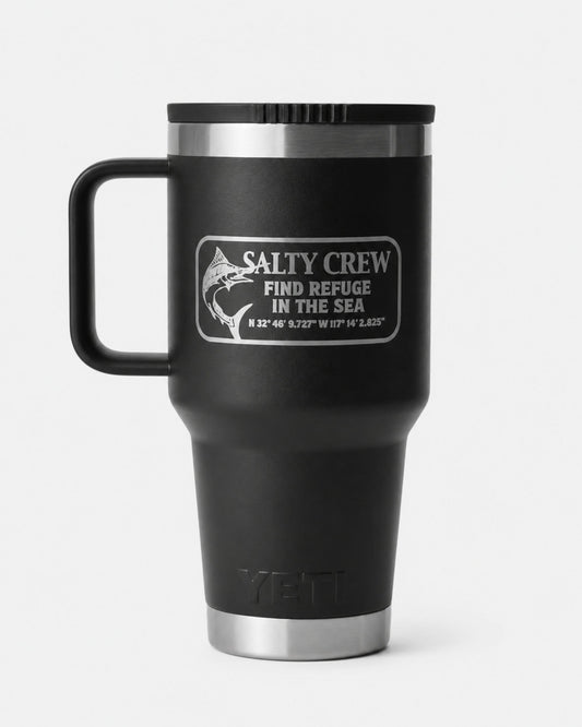 The Salty Crew Yeti x Salty Crew Travel Straw Mug 30 Oz in black is a vacuum-insulated stainless steel mug with handle, featuring a fish graphic, coordinates, and "Find Refuge in the Sea" on a crisp white background.