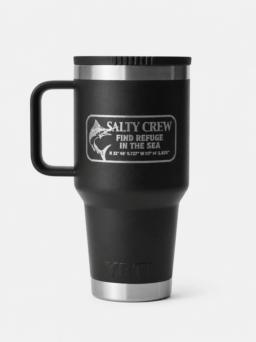The Salty Crew Yeti x Salty Crew Travel Straw Mug 30 Oz in black is a vacuum-insulated stainless steel mug with handle, featuring a fish graphic, coordinates, and "Find Refuge in the Sea" on a crisp white background.