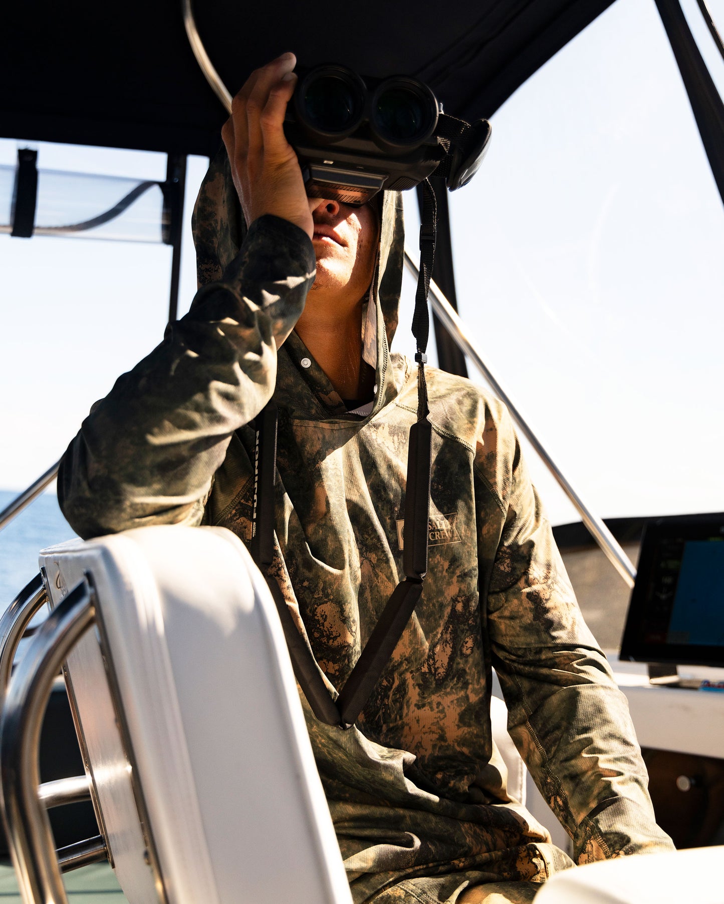 Lifestyle shot of the Apex Perforated Sunshirt Hoodie - Deep Forest. 