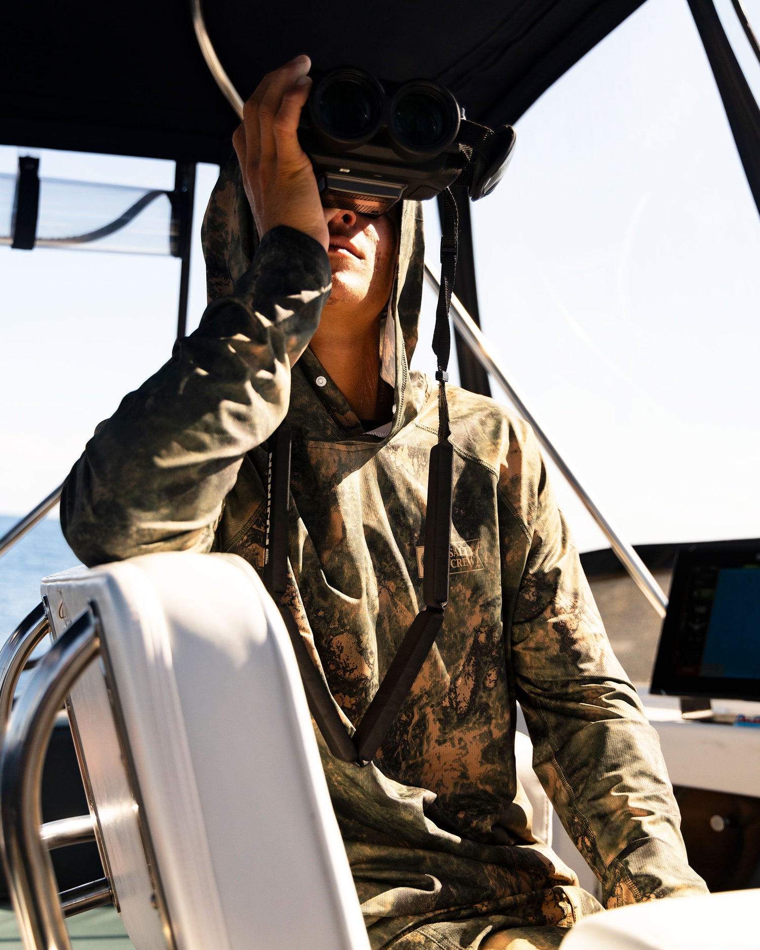 Lifestyle shot of the Apex Perforated Sunshirt Hoodie - Deep Forest. 