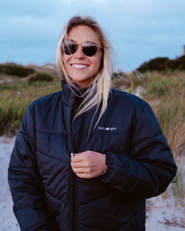 Lifestyle shot of the Barrier Puffer Jacket - Black. 