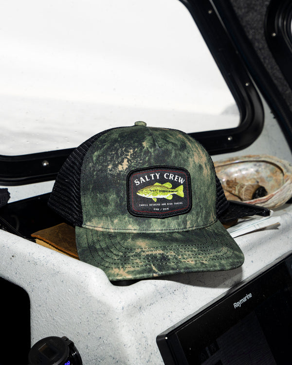 Lifestyle shot of the Bigmouth Trucker Hat - Deep Forest. 
