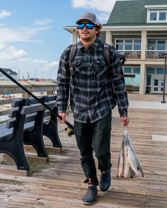 Lifestyle shot of the Fathom Tech Flannel - Pirate Black. 