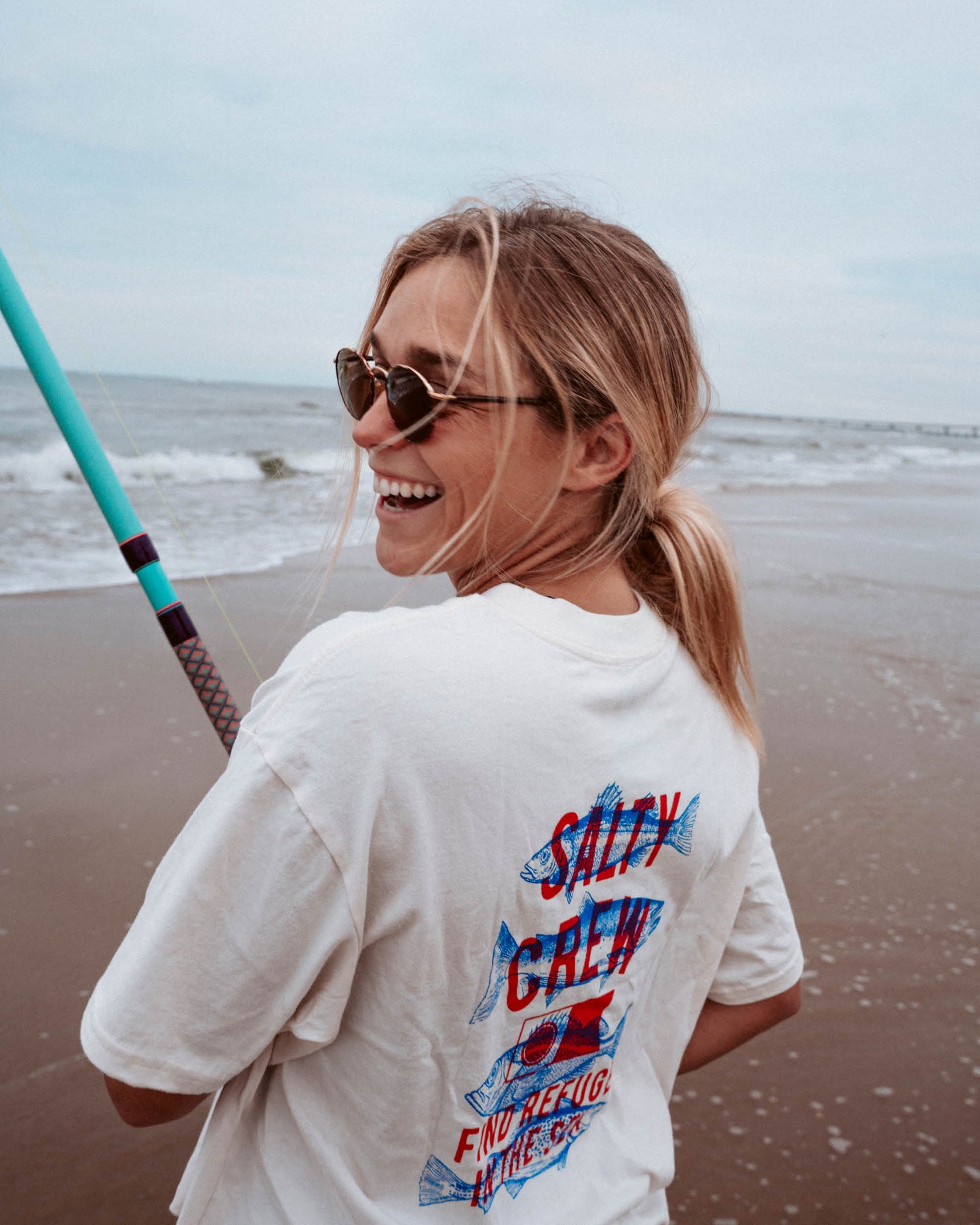 Lifestyle shot of the Fish Finder Skimmer Tee - Off White. 