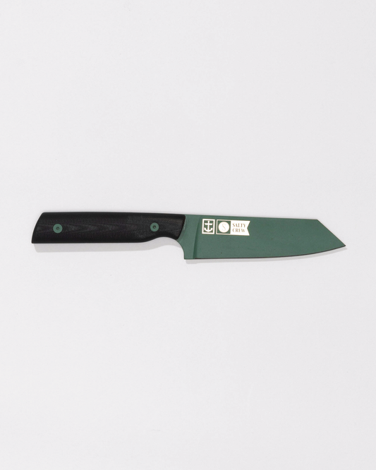 The Salty Crew Leucadia x Salty Crew 5” Snapper Utility Knife features a short, straight Detroit Diesel Green blade with logos and text, a dark handle, and includes a handmade leather sheath. Photographed on a plain white background.