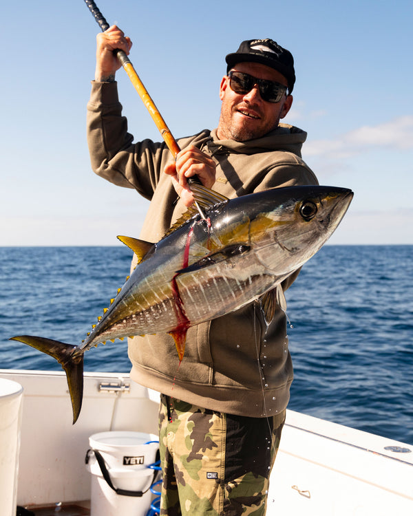 Lifestyle shot of the Long Range Tech Fleece Hoodie - Olive. 