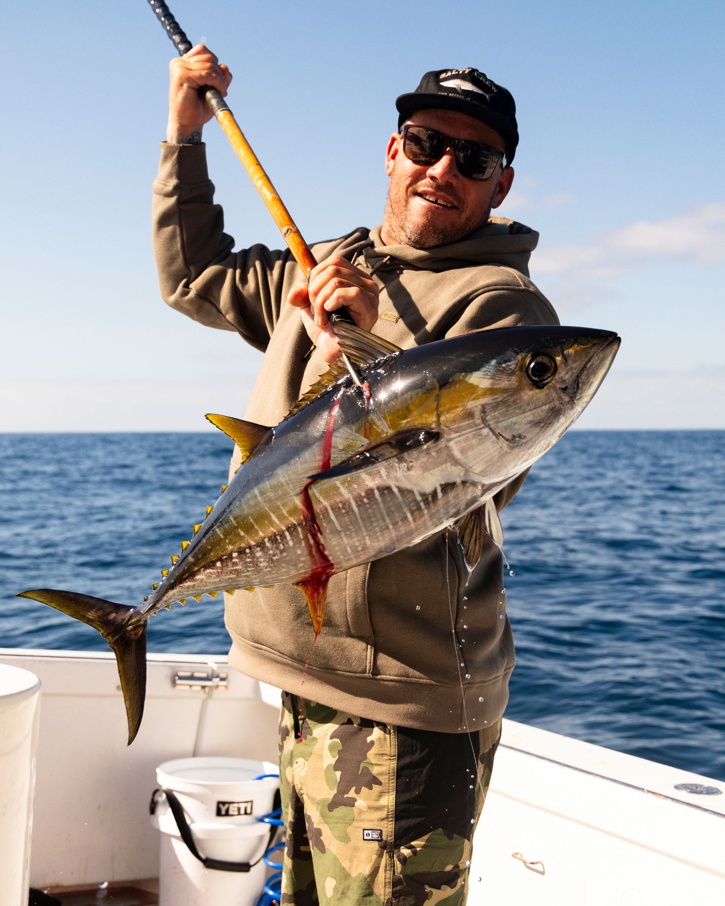 Lifestyle shot of the Long Range Tech Fleece Hoodie - Olive. 