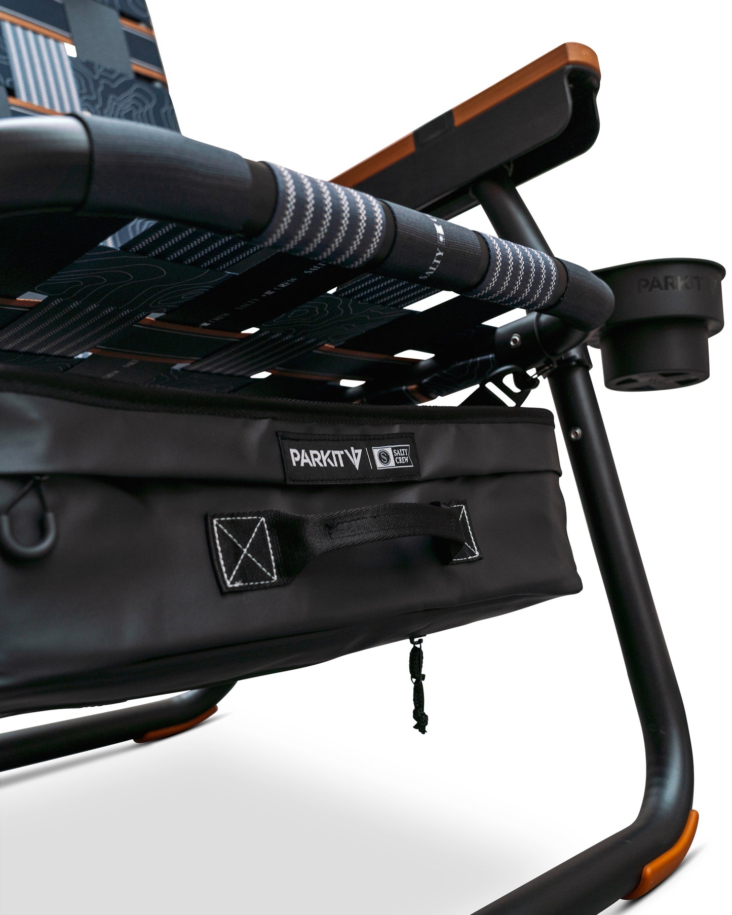 Close-up of the Parkit x Salty Crew Eclipse Recliner Chair by PARKIT Co. in black, featuring patterned fabric, a sturdy frame, attached storage pouch, integrated cooler, and a cup holder on the armrest.