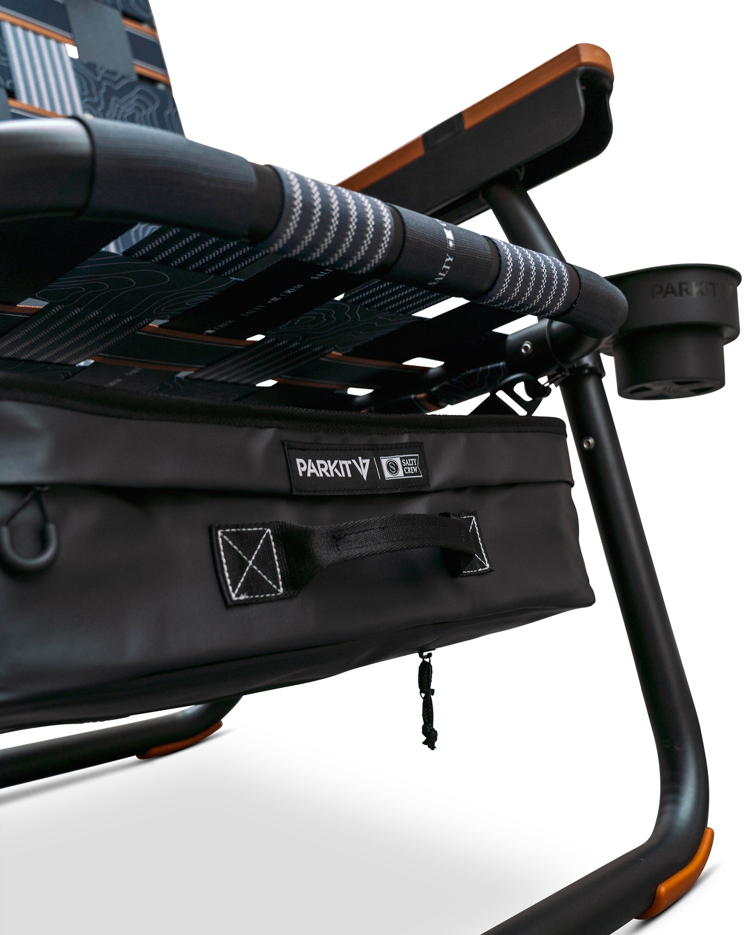 Close-up of the Parkit x Salty Crew Eclipse Recliner Chair by PARKIT Co. in black, featuring patterned fabric, a sturdy frame, attached storage pouch, integrated cooler, and a cup holder on the armrest.