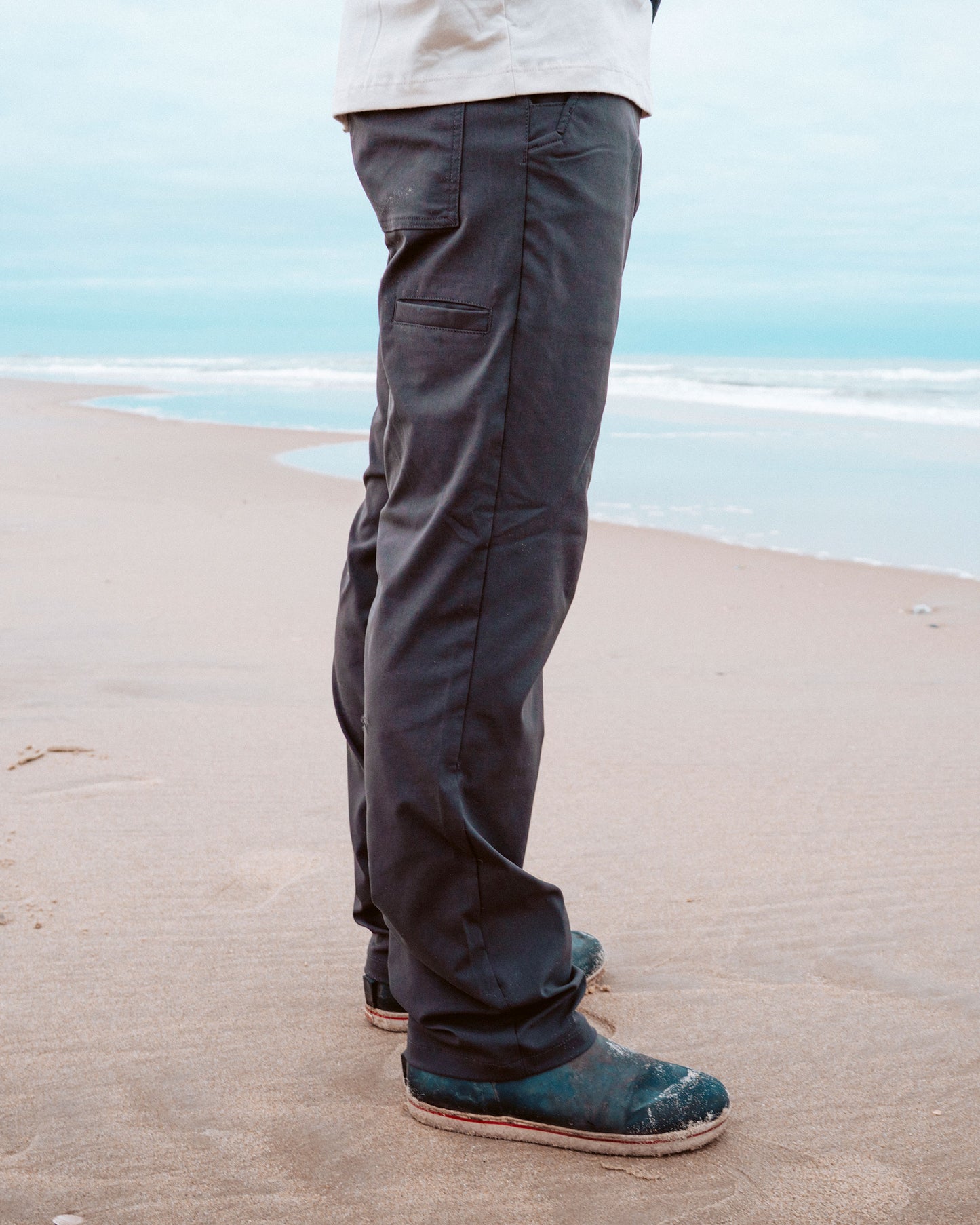 Lifestyle shot of the Transom Tech Pants - Black. 