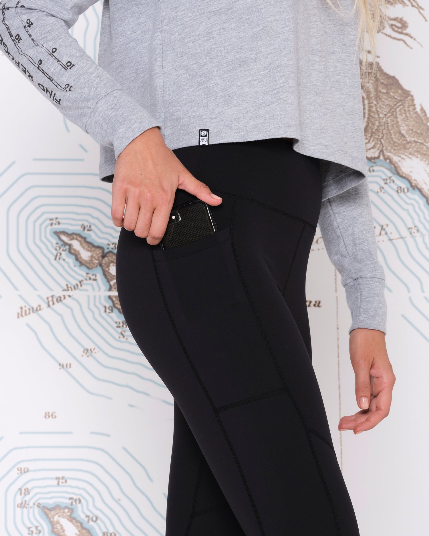 On body front angled detailing of Salty Crew Black Signature Legging