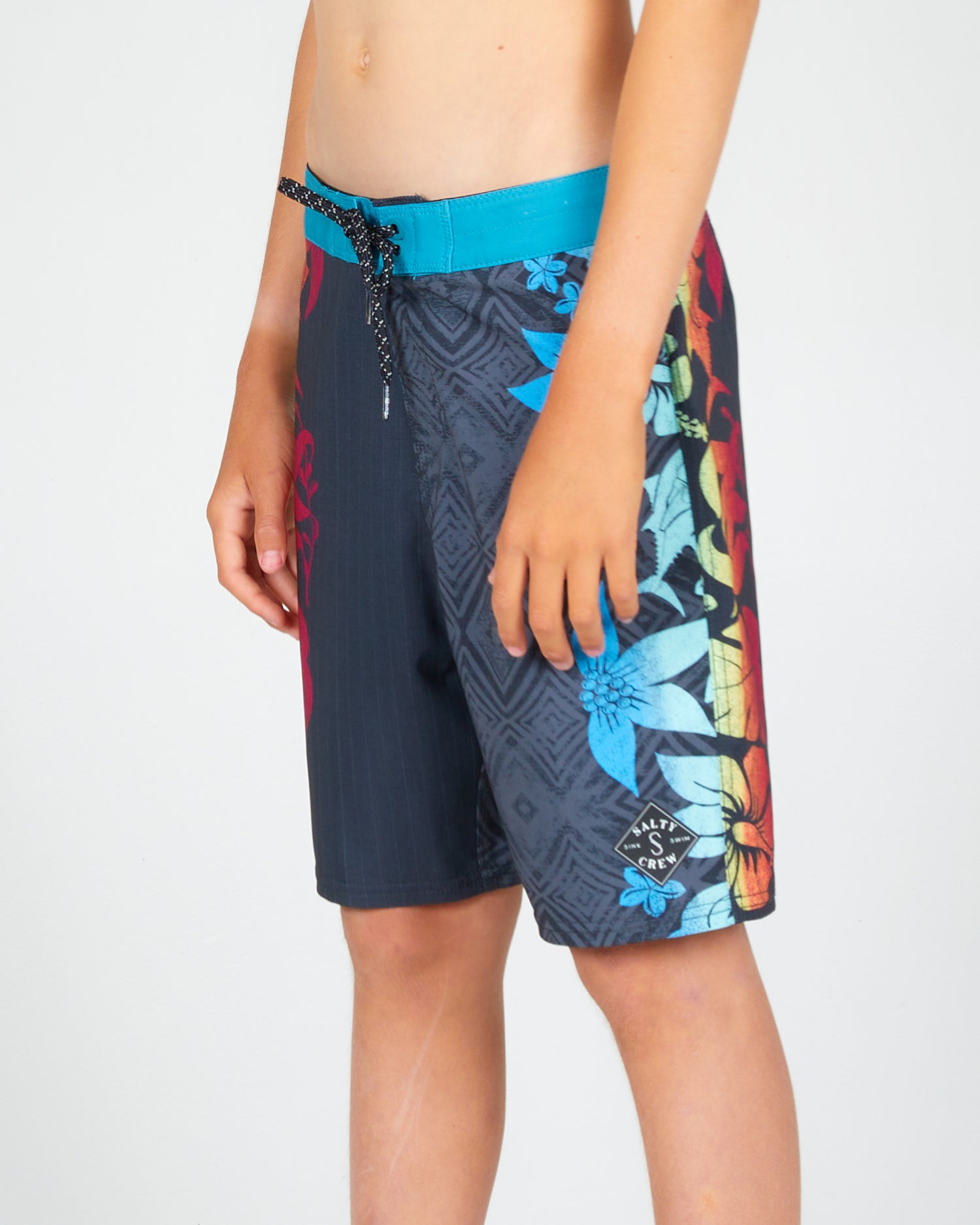 On body front angled view of the Cedros Boys Black/Aqua Boardshort